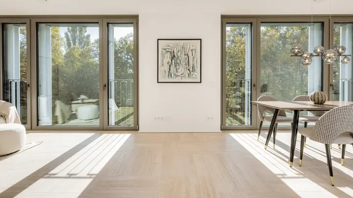 Offener Wohn- und Essbereich mit Fensterfront in einem Neubau mit besonderer Architektur
